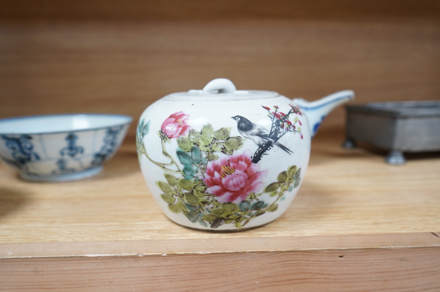 Three pieces of Chinese blue and white porcelain, including a double lipped sauceboat, 8.5cm high, and a famille rose lidded pot. Condition - fair